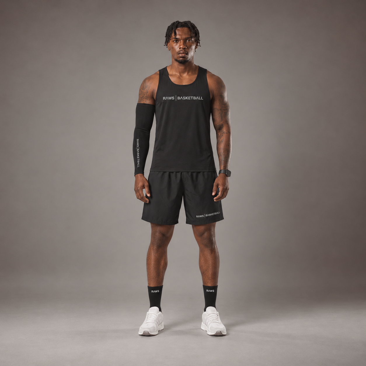 Model wearing the RAWS Basketball Vest in Black with Shooting Sleeve, Shooting Shorts and Socks, front view