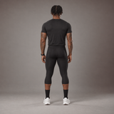 Model wearing the RAWS Basketball Compression T-Shirt and Compression 3/4 Leggings in Black, back view
