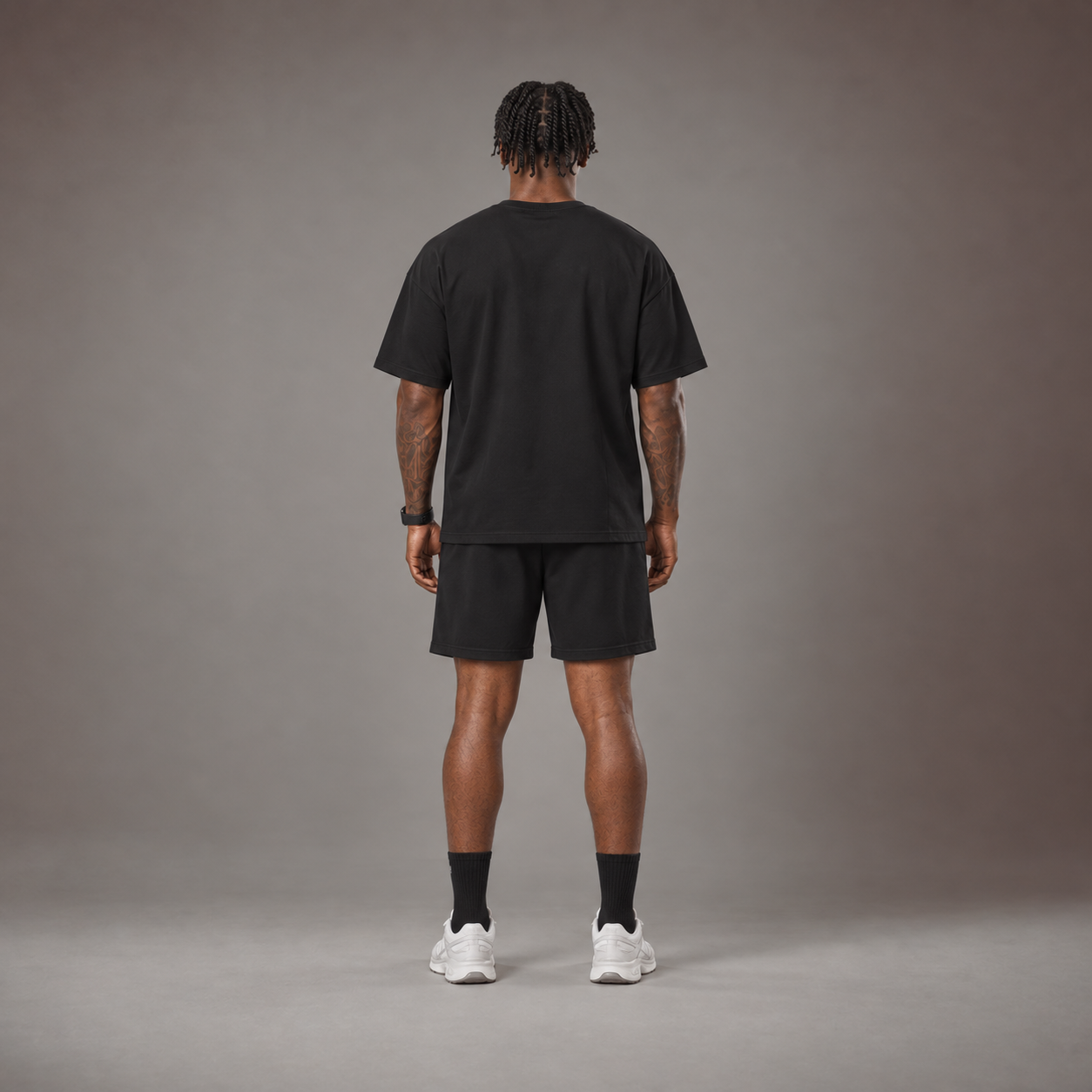 Model wearing the RAWS Off-Court T-Shirt and Shorts in Black, back view