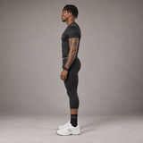 Model wearing the RAWS Basketball Compression T-Shirt and Compression 3/4 Leggings in Black, side view