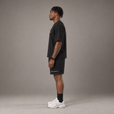Model wearing the RAWS Off-Court T-Shirt and Shorts in Black, side view