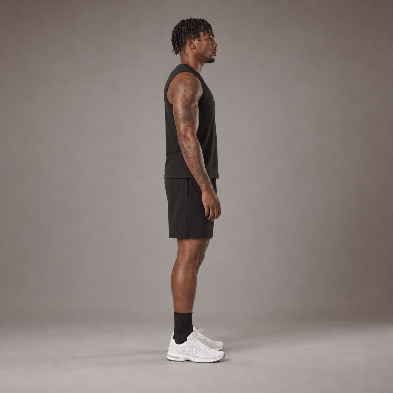 Model wearing the RAWS Off-Court Tank Top and Shorts in Black, side view