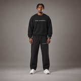 Model wearing the RAWS Off-Court Crew Sweatshirt and Joggers in Black, front view