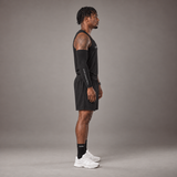 Model wearing the RAWS Basketball Vest in Black with Shooting Sleeve, Shooting Shorts and Socks, side view