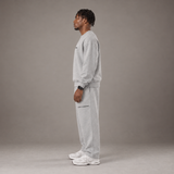 Model wearing the RAWS Off-Court Crew Sweatshirt and Joggers in Grey, side view
