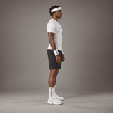 Model wearing the RAWS Basketball Compression T-Shirt in White with Headband, Sweatbands and Shooting Shorts, side view