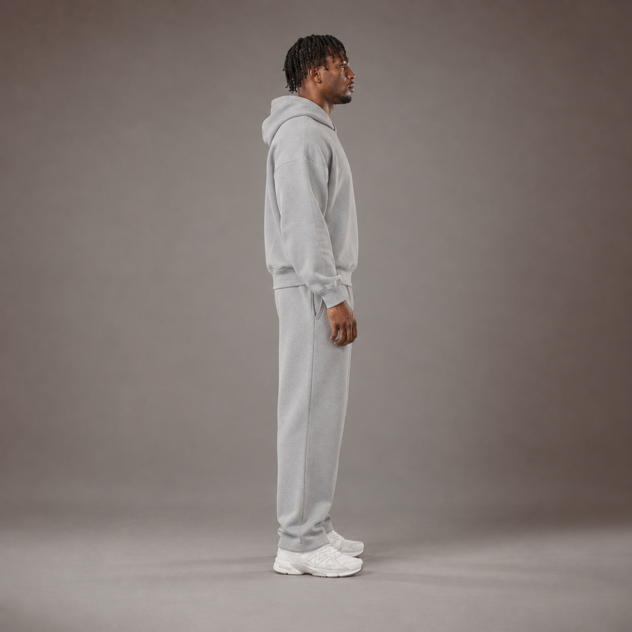 Model wearing the RAWS Off-Court Hoodie and Joggers in Grey, side view