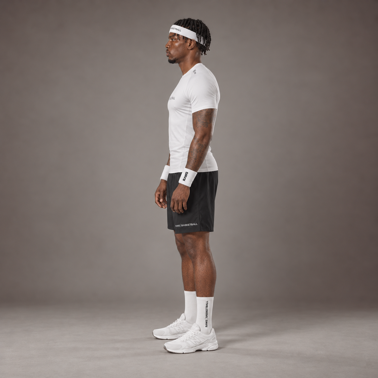 Model wearing the RAWS Basketball Compression T-Shirt in White with Headband, Sweatbands and Shooting Shorts, side view