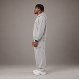 Model wearing the RAWS Off-Court Hoodie and Joggers in Grey, side view