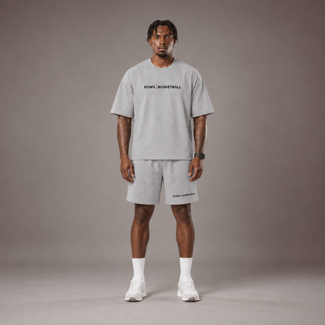 Model wearing the RAWS Off-Court T-Shirt and Shorts in Grey, front view