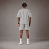 Model wearing the RAWS Off-Court T-Shirt and Shorts in Grey, back view
