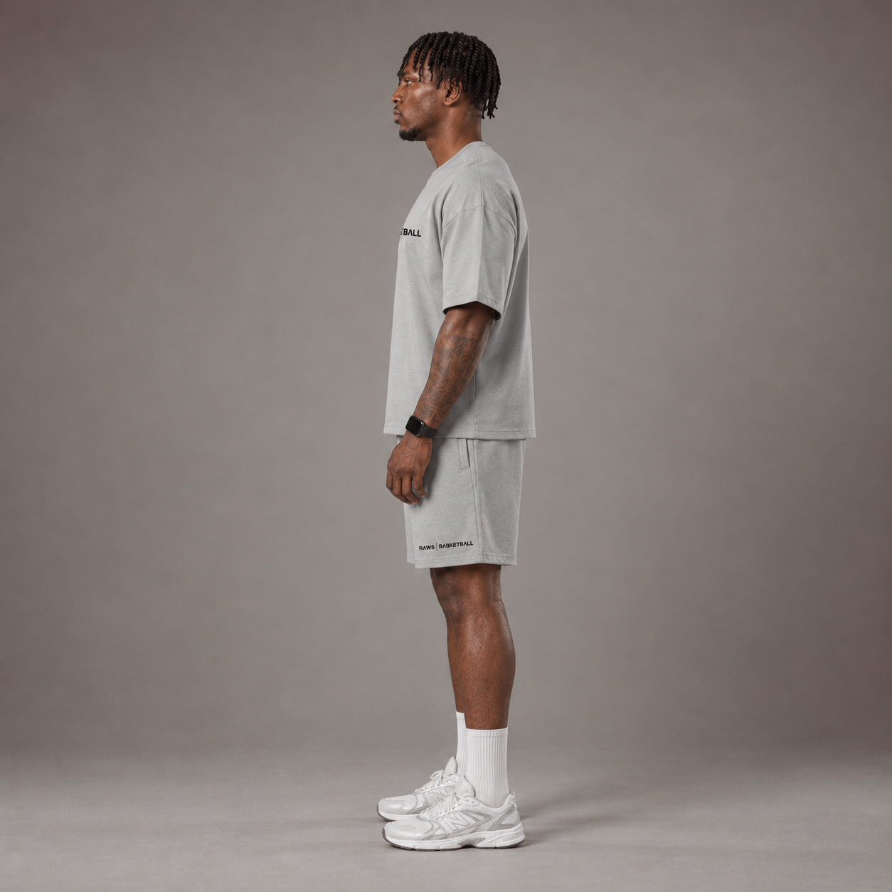 Model wearing the RAWS Off-Court T-Shirt and Shorts in Grey, side view