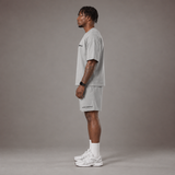 Model wearing the RAWS Off-Court T-Shirt and Shorts in Grey, side view