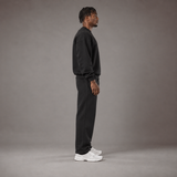Model wearing the RAWS Off-Court Crew Sweatshirt and Joggers in Black, side view