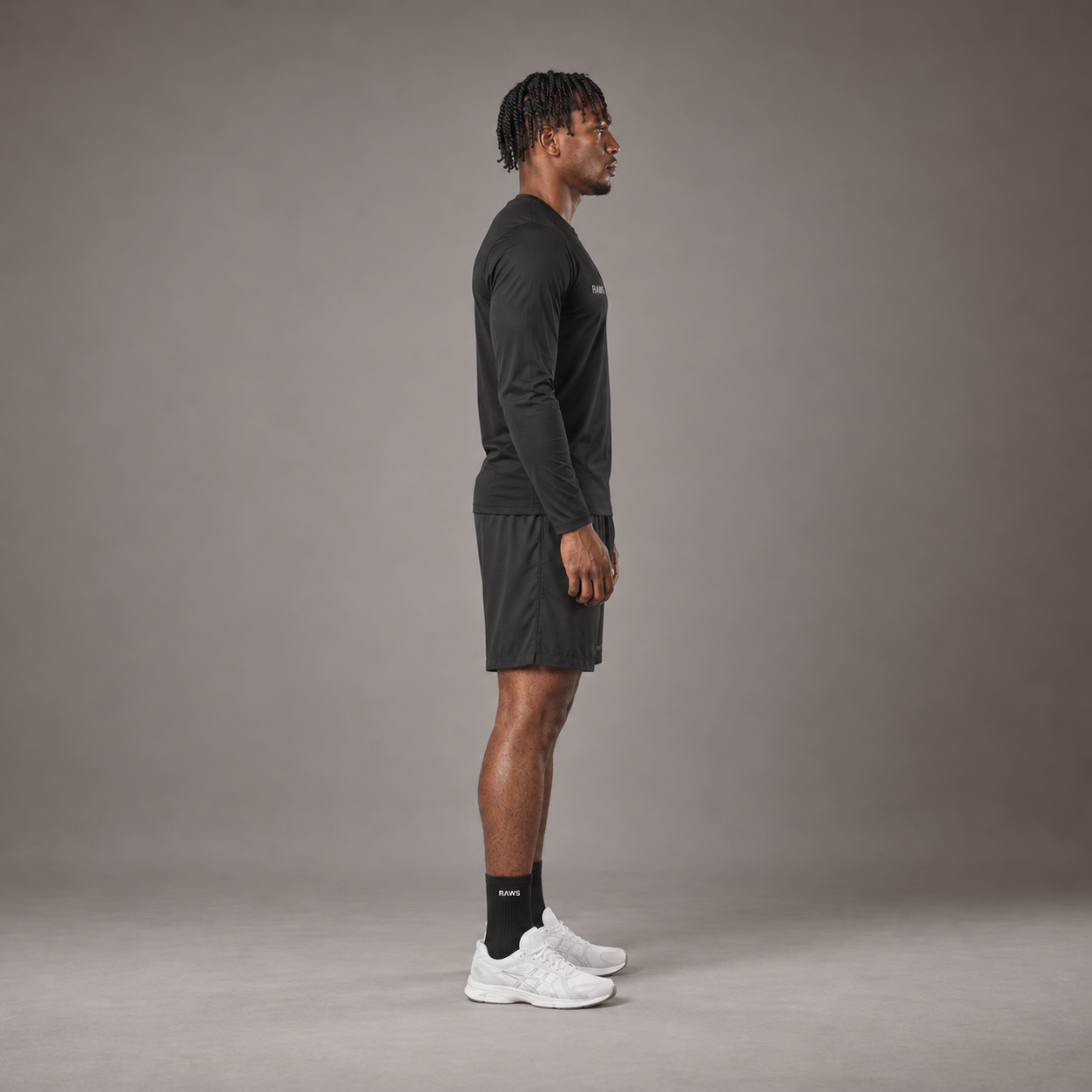 Model wearing the RAWS Basketball Shooting Long Sleeve T-Shirt in Black with Shooting Shorts, side view