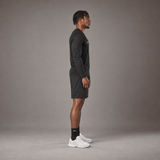 Model wearing the RAWS Basketball Shooting Long Sleeve T-Shirt in Black with Shooting Shorts, side view