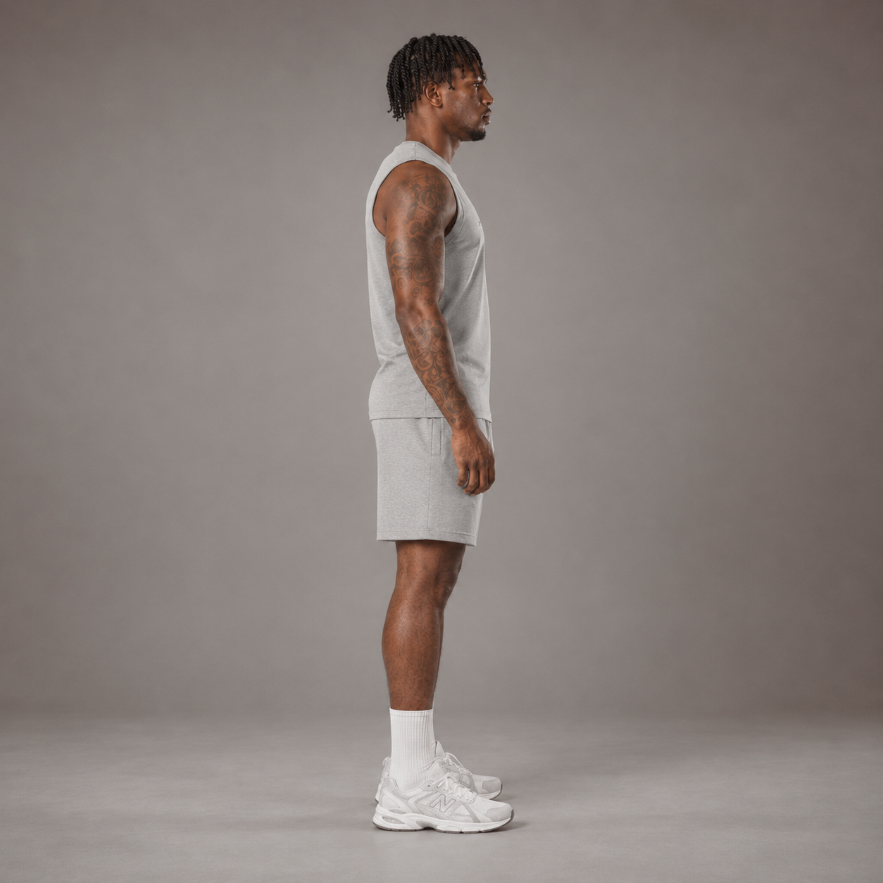 Model wearing the RAWS Off-Court Tank Top and Shorts in Grey, side view