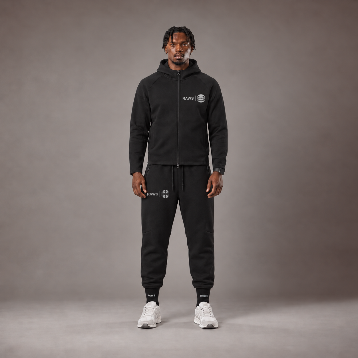 Model wearing the RAWS Basketball Tech Hoodie and Tech Pants in Black, front view