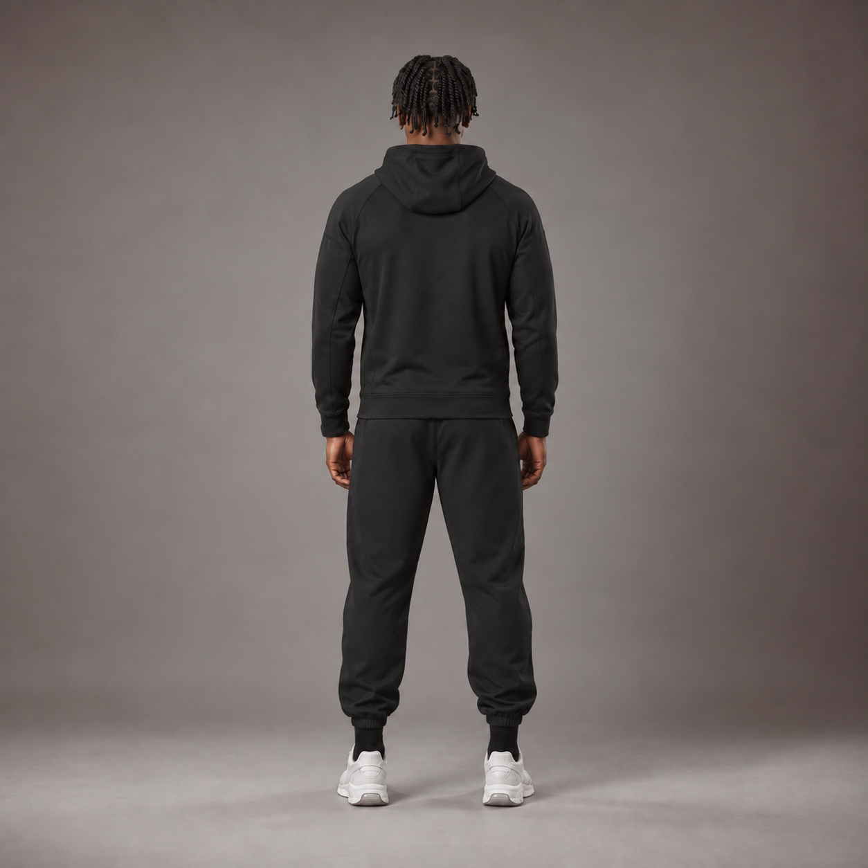Model wearing the RAWS Basketball Tech Hoodie and Tech Pants in Black, back view
