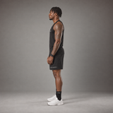 Model wearing the RAWS Basketball Vest in Black with Shooting Sleeve, Shooting Shorts and Socks, side view