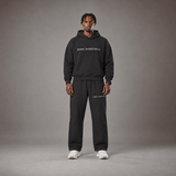 Model wearing the RAWS Off-Court Hoodie and Joggers in Black, front view