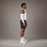 Model wearing the RAWS Basketball Vest in White with Shooting Sleeve, Shooting Shorts and Socks, side view