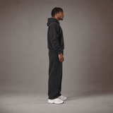 Model wearing the RAWS Off-Court Hoodie and Joggers in Black, side view