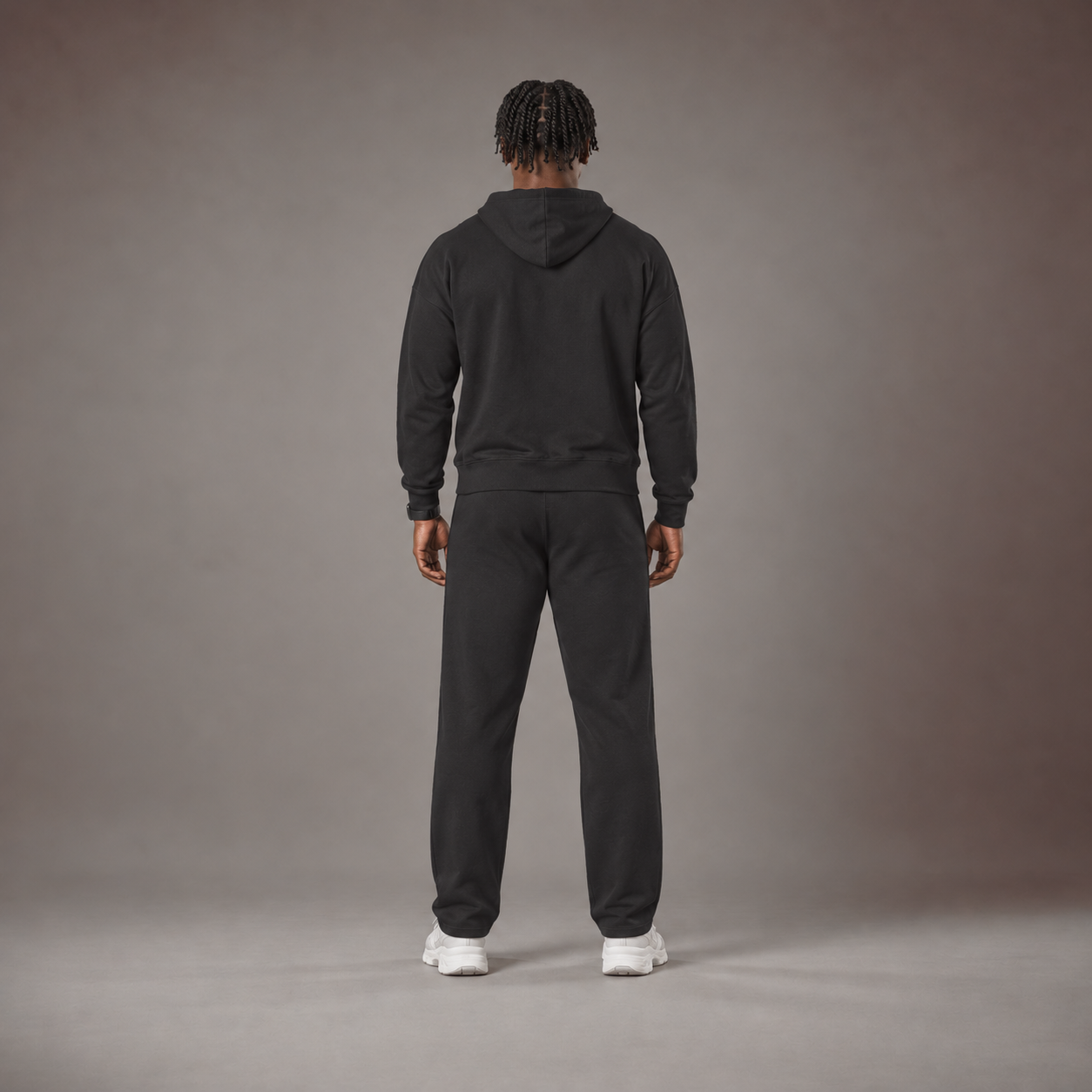 Model wearing the RAWS Off-Court Hoodie and Joggers in Black, back view