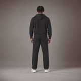 Model wearing the RAWS Off-Court Hoodie and Joggers in Black, back view