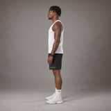 Model wearing the RAWS Basketball Vest in White with Shooting Sleeve, Shooting Shorts and Socks, side view