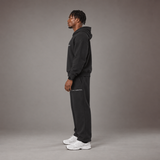 Model wearing the RAWS Off-Court Hoodie and Joggers in Black, side view